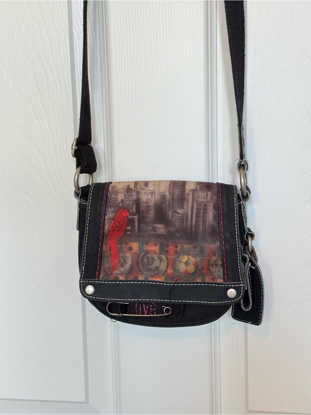 Sherpani Black Crossbody Bag with Red Parrot Accent